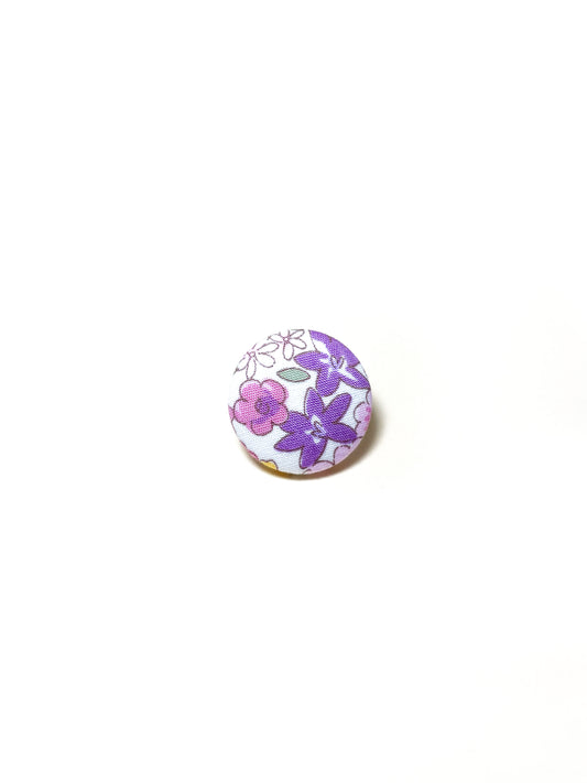 Handmade purple floral fabric covered lapel pin.