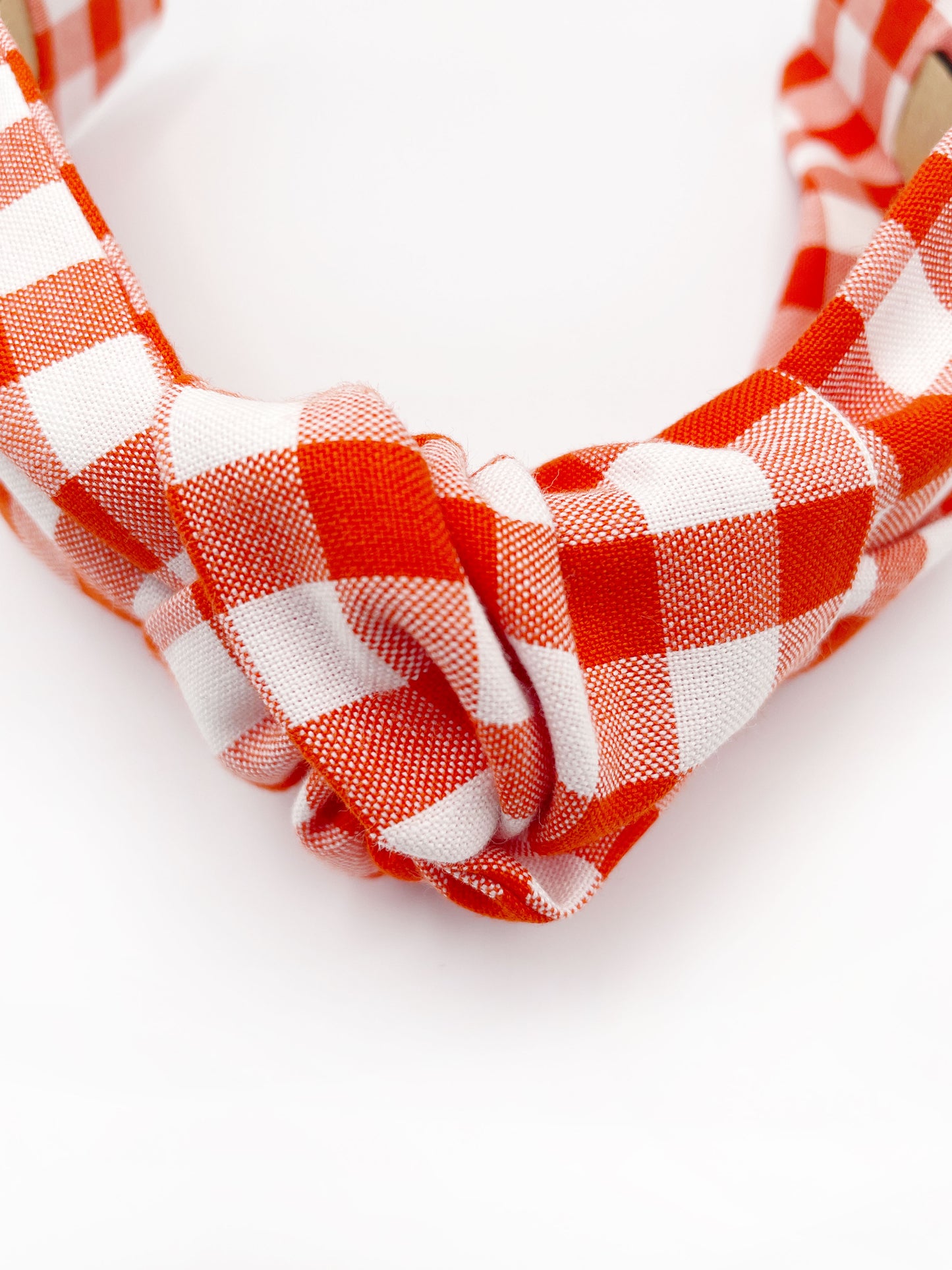 Cotton knotted headbands with a vibrant red gingham plaid print. 