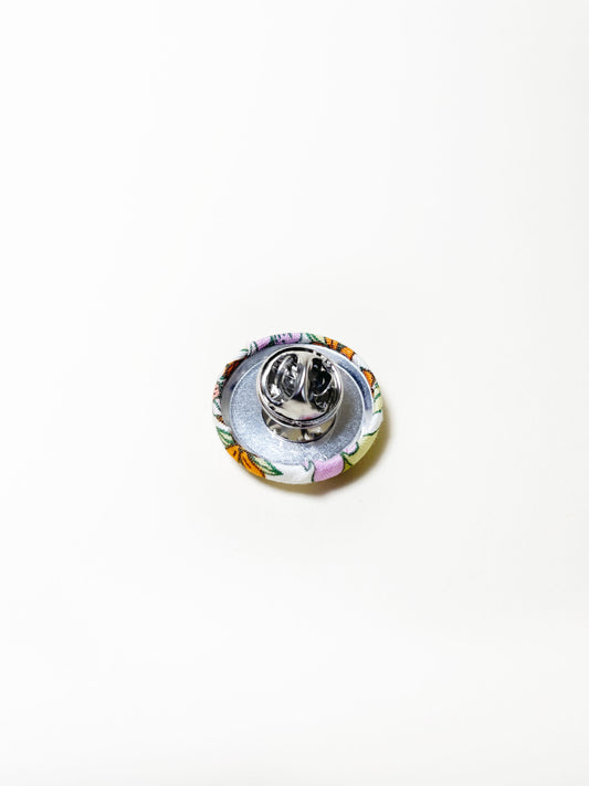 Handmade retro floral fabric covered lapel pin. Each pin has a clutch back closure.