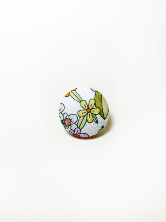 Handmade retro floral fabric covered lapel pin.