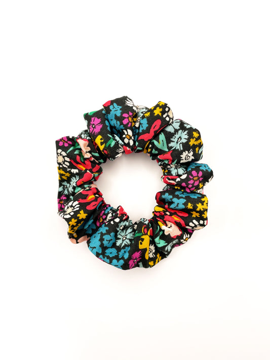 A handmade scrunchie with vibrant flowers. 