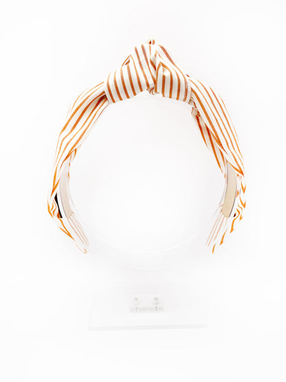 A handmade copper striped knotted headband.