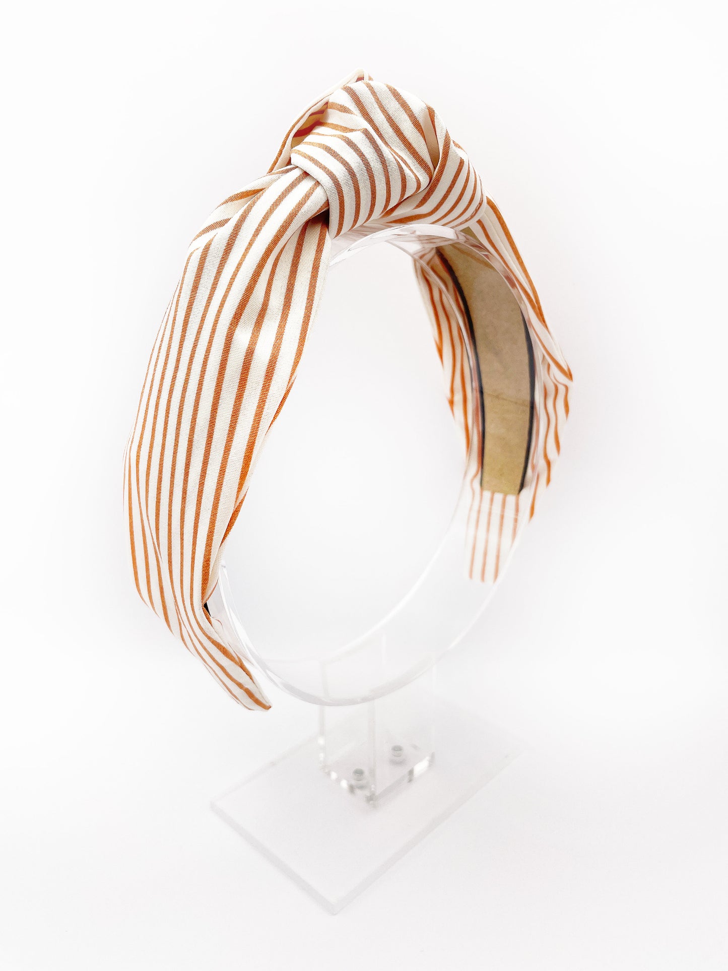 A handmade copper striped knotted headband.