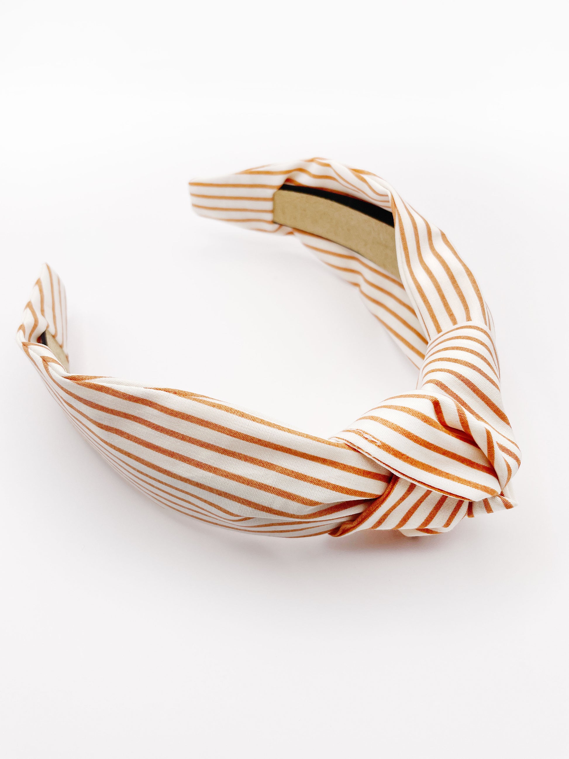 A handmade copper striped knotted headband.