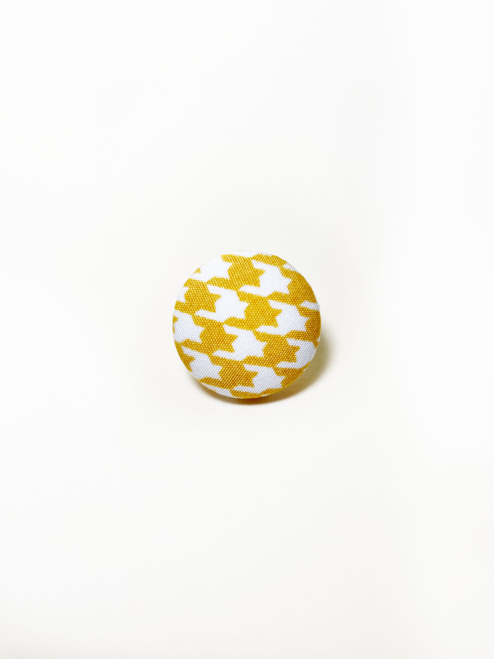 Handmade yellow houndstooth fabric covered lapel pin.