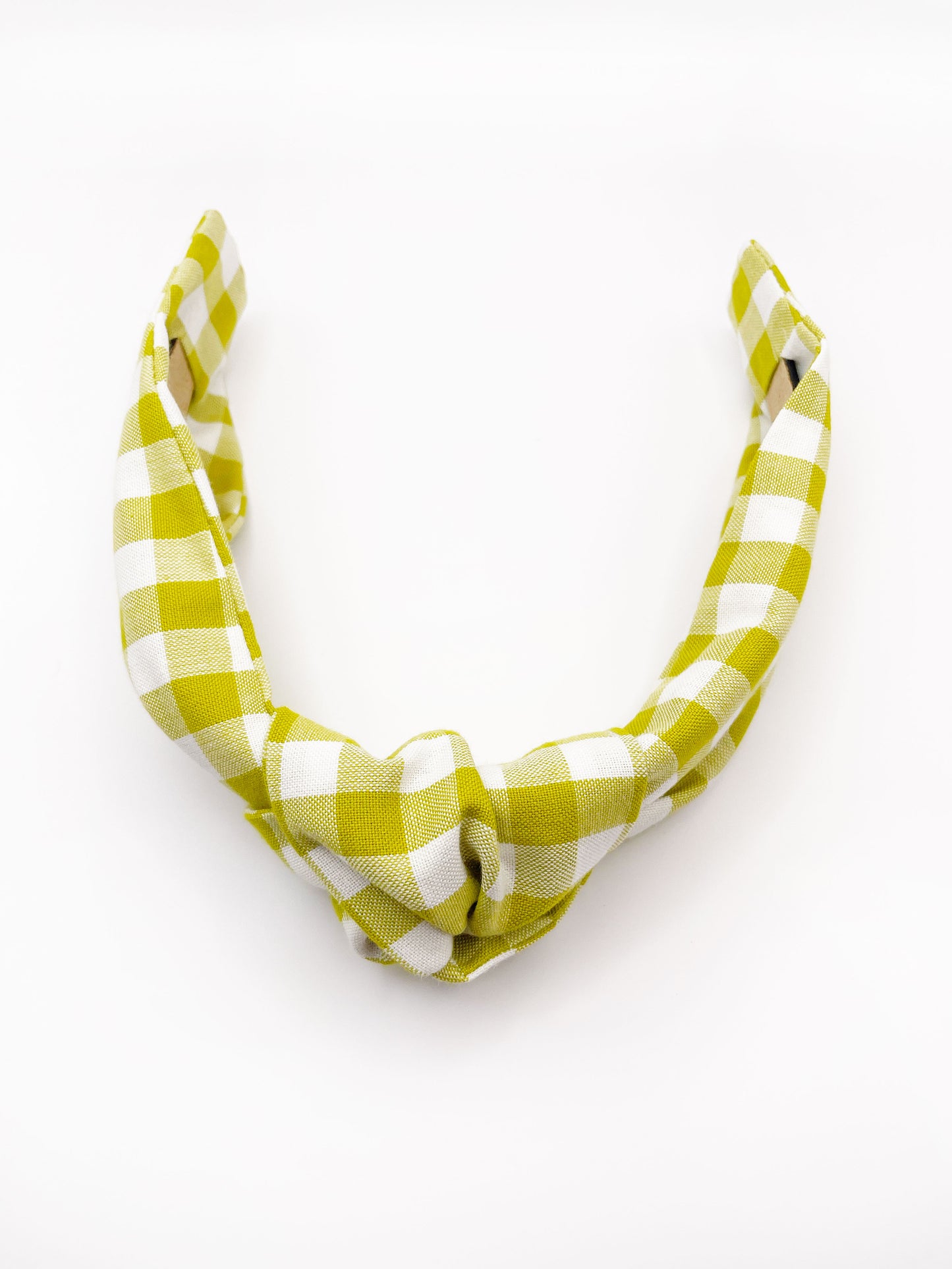 A knotted headband with a green and white gingham plaid print.