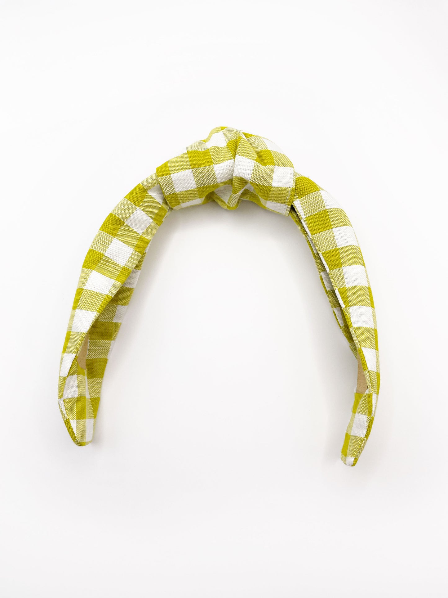 A knotted headband with a green and white gingham plaid print.