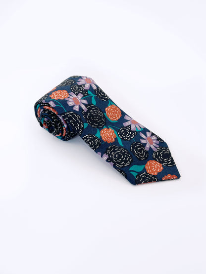 A navy blue necktie with vivid orange, lavender, and black flowers, accented with fresh green leaves.