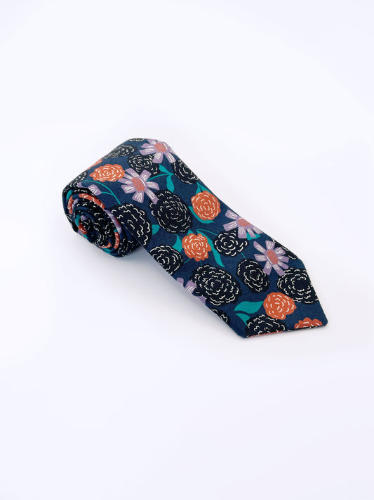 A navy blue necktie with vivid orange, lavender, and black flowers, accented with fresh green leaves.