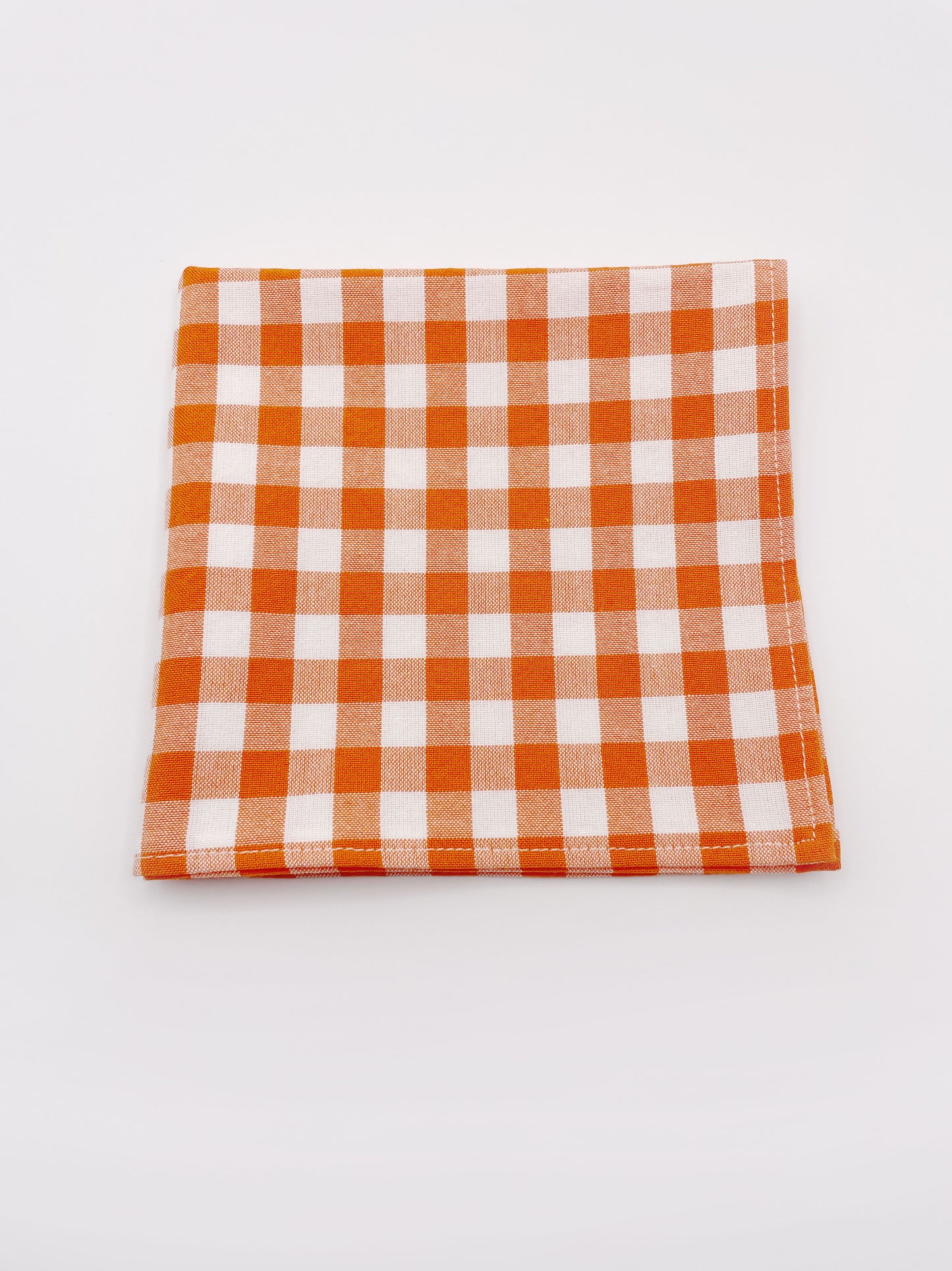 An orange and white gingham plaid pocket square.