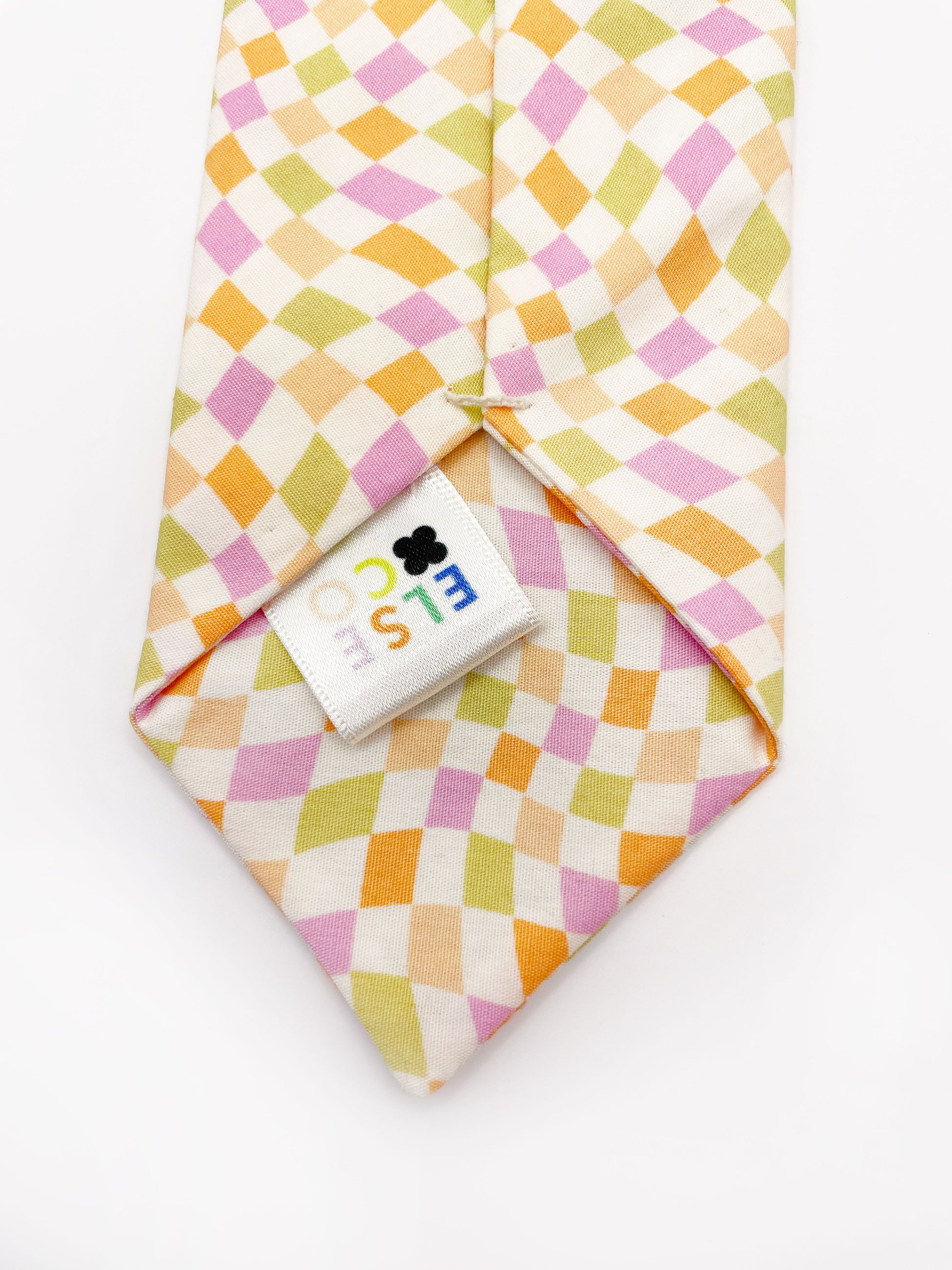 A handmade necktie with a pastel checkered print. Each necktie is carefully hand-stitched.