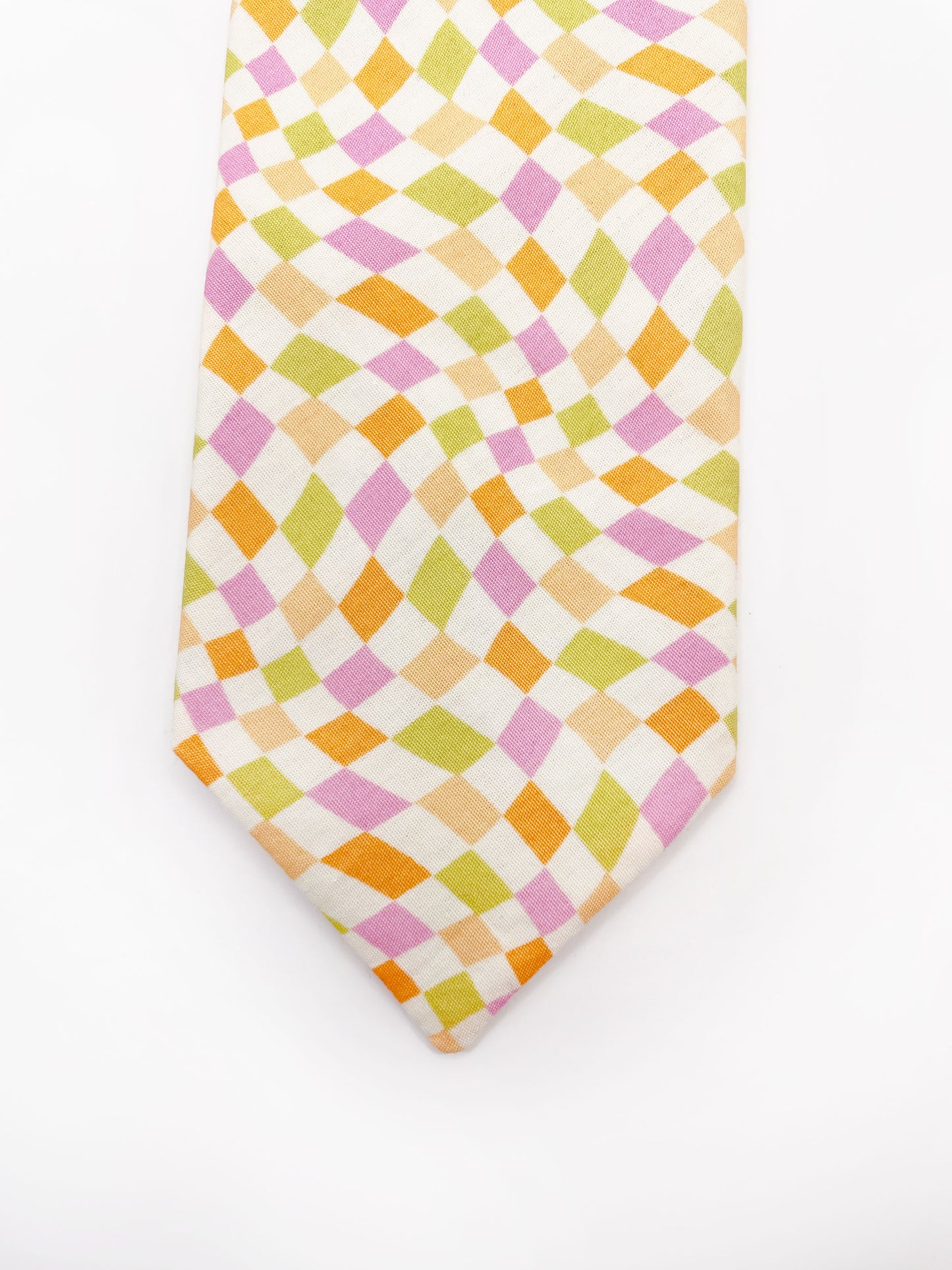 A handmade necktie with a pastel checkered print.