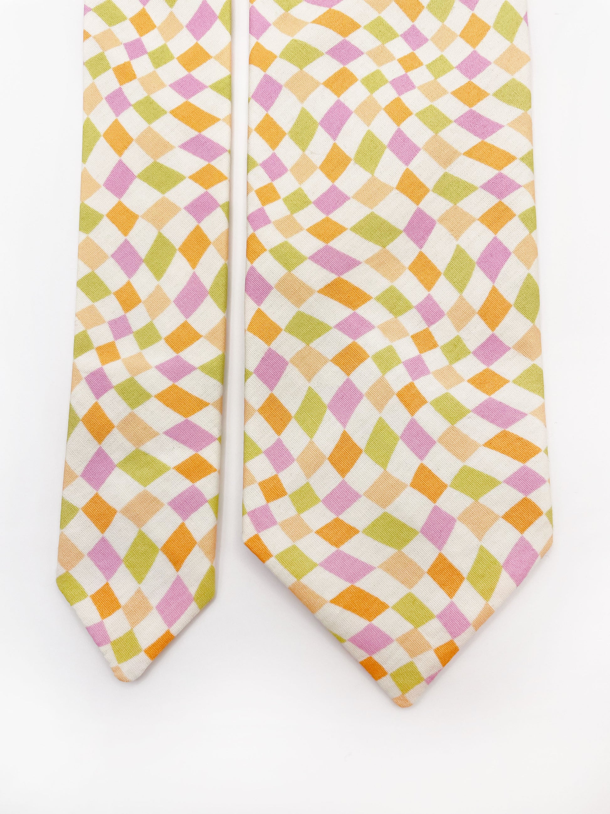 A handmade necktie with a pastel checkered print.