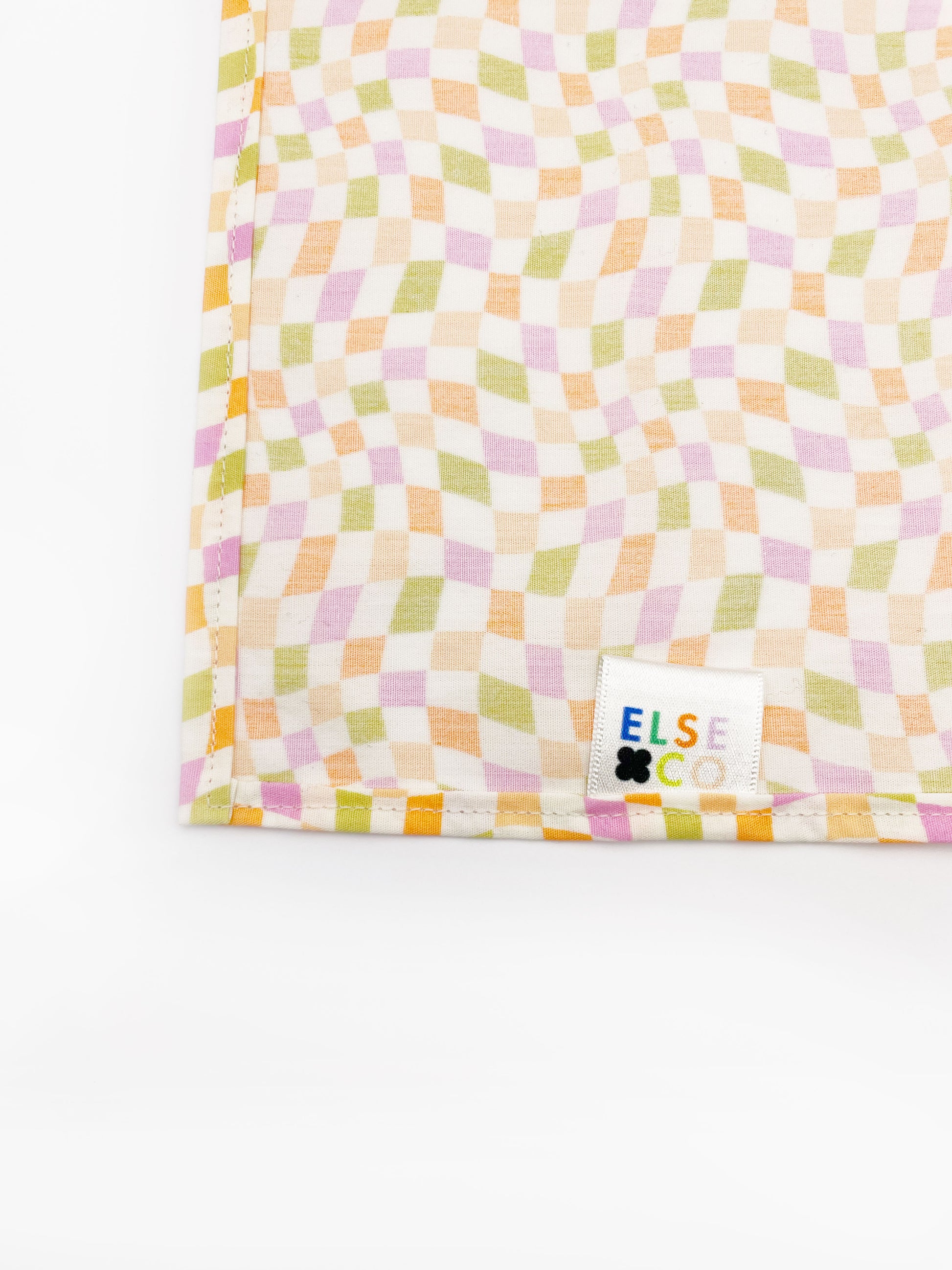 A handmade pocket square with a pastel checkered print. 