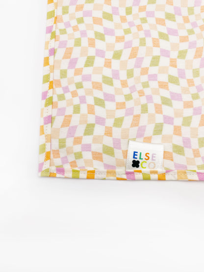 A handmade pocket square with a pastel checkered print. 