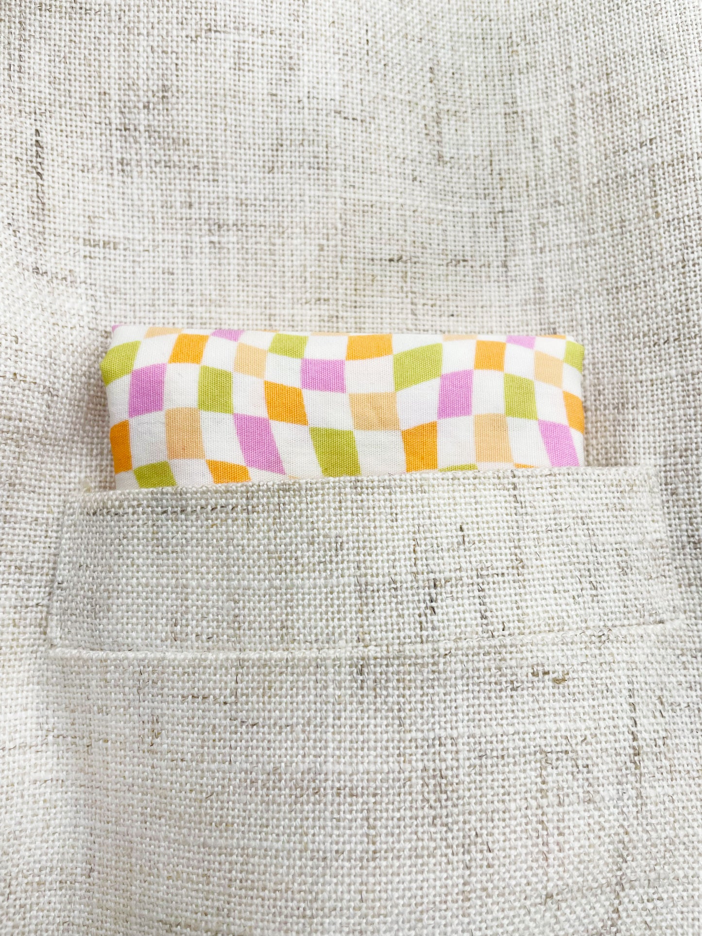 A handmade pocket square with a pastel checkered print. 