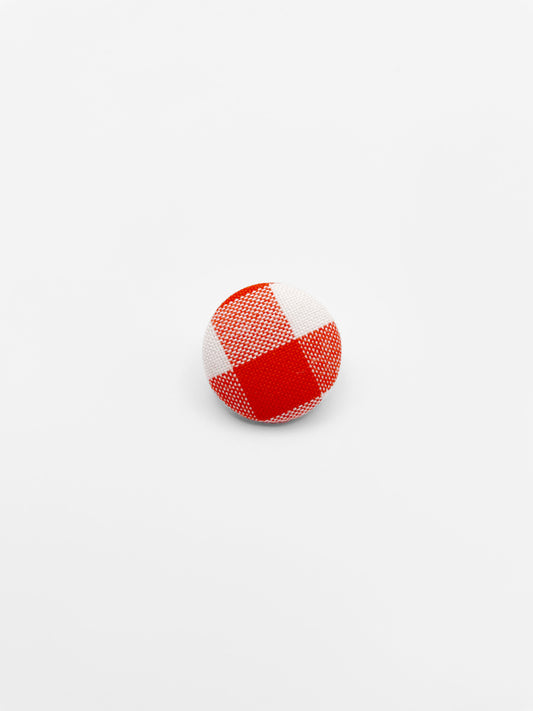 Handmade fabric-covered lapel pin with a rich red gingham plaid print. 