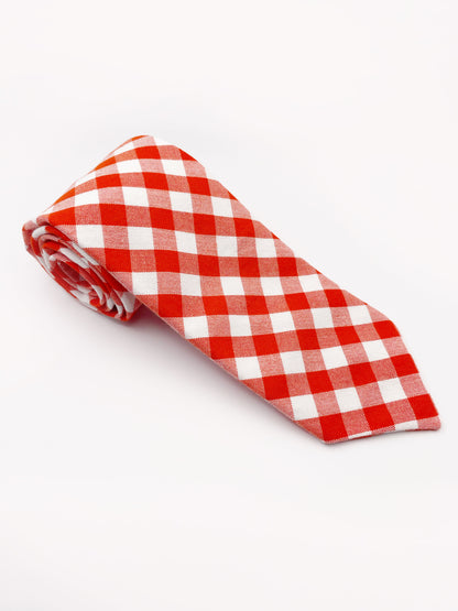 A cotton necktie with a vibrant red gingham plaid print.