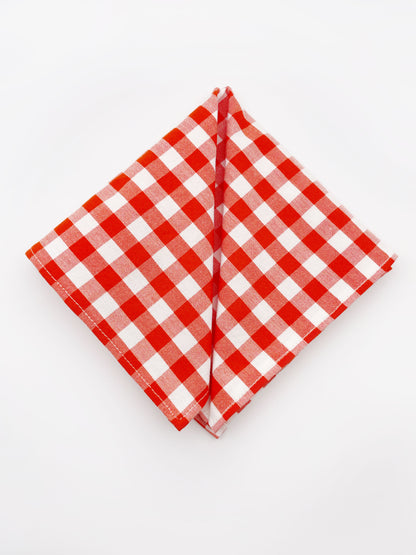 A cotton handmade pocket square with a red gingham plaid print. 