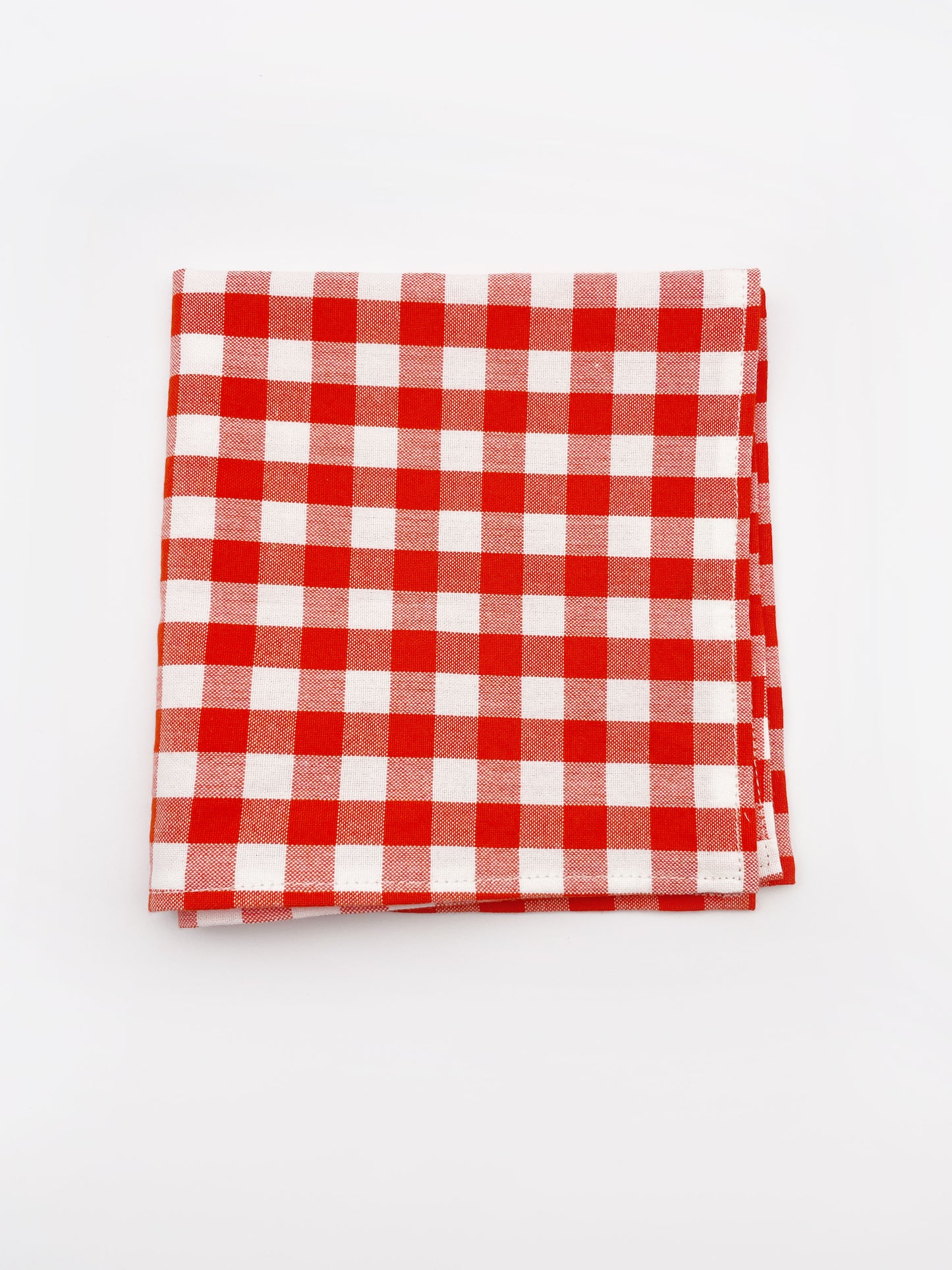 A cotton handmade pocket square with a red gingham plaid print. 