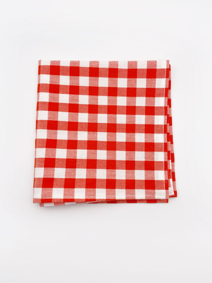 A cotton handmade pocket square with a red gingham plaid print. 