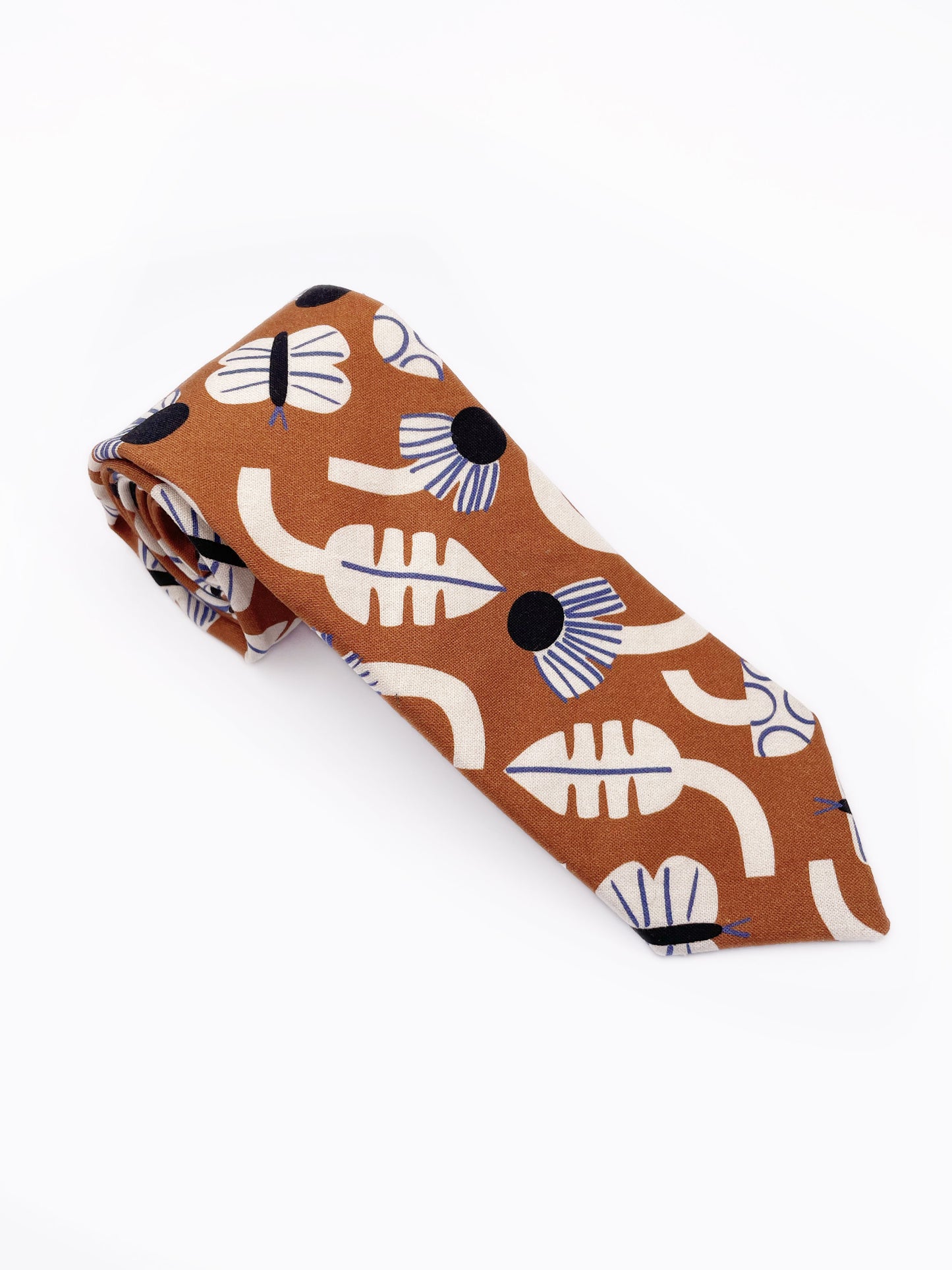 A necktie with an abstract print featuring flowers, leaves, mushrooms, and butterflies on a rich terracotta background. The color palette also consists of cream, black, and blue.