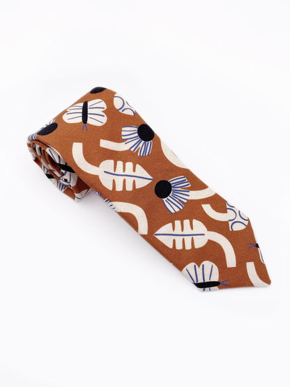 A necktie with an abstract print featuring flowers, leaves, mushrooms, and butterflies on a rich terracotta background. The color palette also consists of cream, black, and blue.
