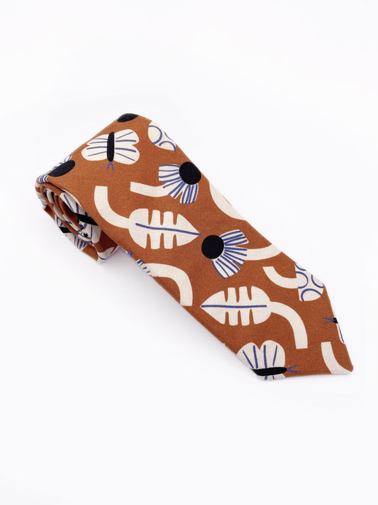 A necktie with an abstract print featuring flowers, leaves, mushrooms, and butterflies on a rich terracotta background. The color palette also consists of cream, black, and blue.