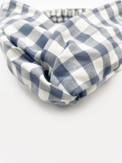 A cotton twist headband with a classic slate blue gingham plaid print. 