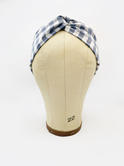 A cotton twist headband with a classic slate blue gingham plaid print. The headband is shown on a mannequin head.