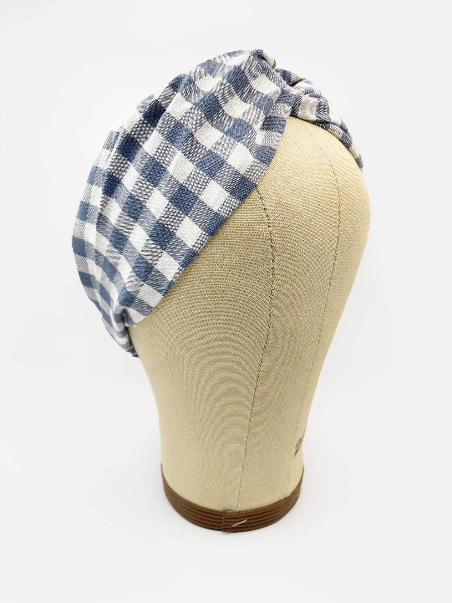 A cotton twist headband with a classic slate blue gingham plaid print. The headband is shown on a mannequin head.