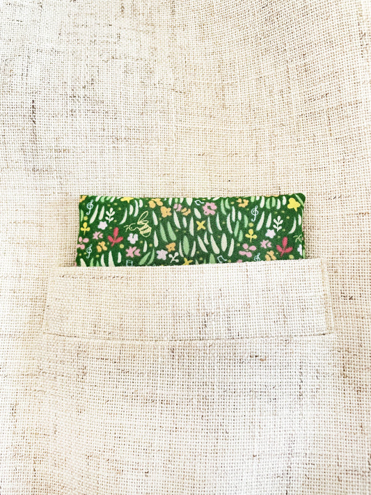 A handmade green floral pocket square with a grass print.