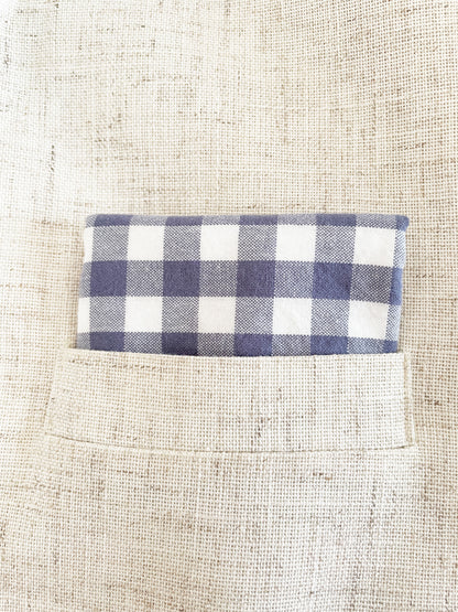A handmade slate blue gingham plaid pocket square in a suit pocket.