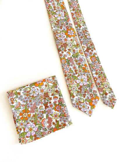 A handmade retro floral pocket square with a matching necktie.