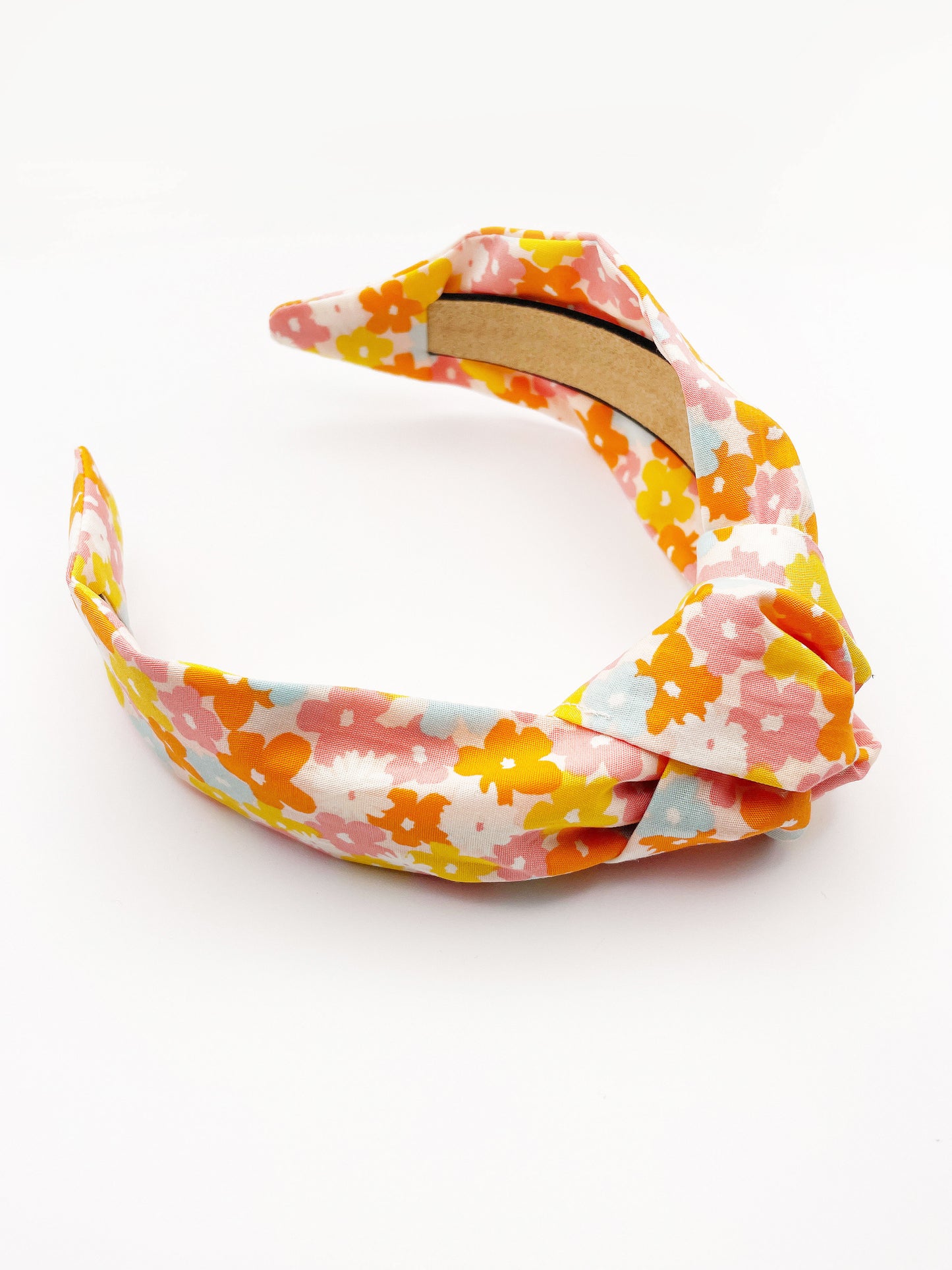 A handmade colorful floral knotted headband.