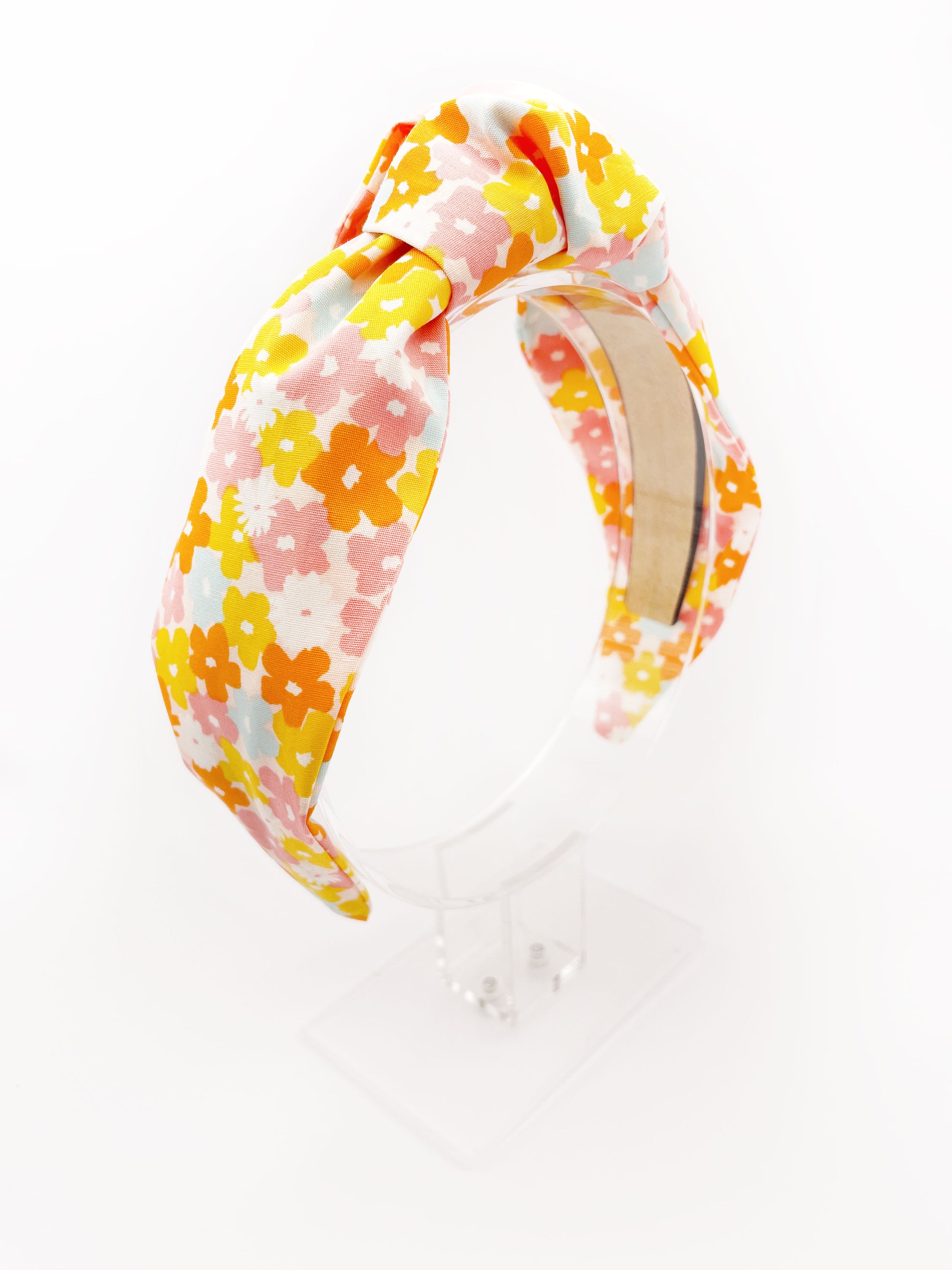 A handmade colorful floral knotted headband.