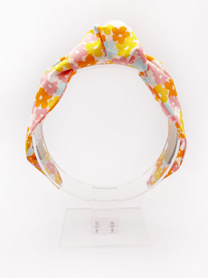 A handmade colorful floral knotted headband.