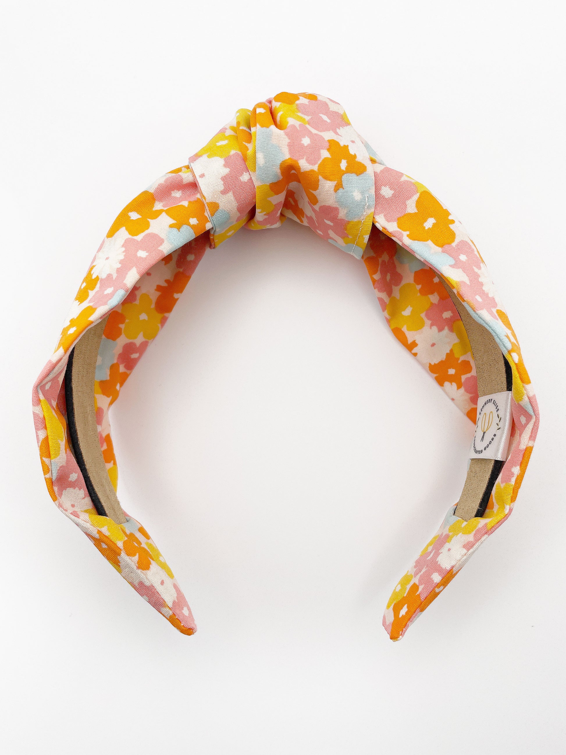 A handmade colorful floral knotted headband.