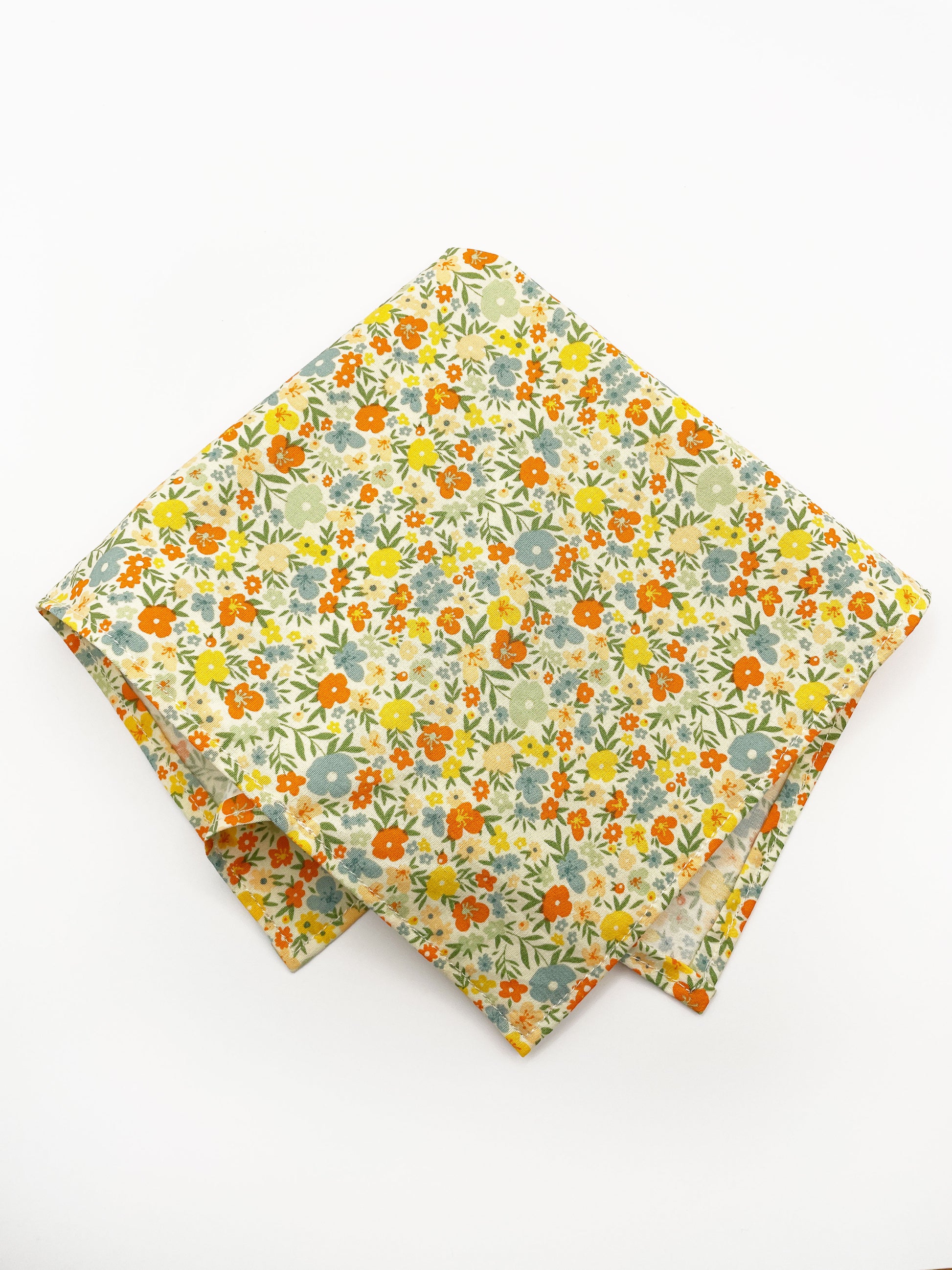 A handmade pocket square featuring colorful flowers.