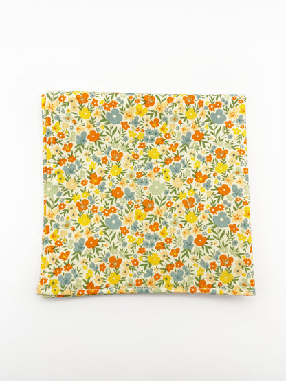 A handmade pocket square featuring colorful flowers.